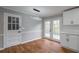 Dining Area with french doors to the exterior deck and modern lighting at 5254 Greenpoint Dr, Stone Mountain, GA 30088