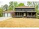 Charming two-story home featuring a welcoming front porch and an attached two-car garage at 5254 Greenpoint Dr, Stone Mountain, GA 30088