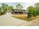 Charming two-story home with a covered porch, and a spacious front yard at 5254 Greenpoint Dr, Stone Mountain, GA 30088