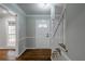 Bright foyer featuring hardwood floors, a staircase, and white trim details at 5254 Greenpoint Dr, Stone Mountain, GA 30088