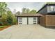 Attached two-car garage featuring stylish modern doors with horizontal window accents at 5254 Greenpoint Dr, Stone Mountain, GA 30088
