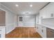 Bright kitchen featuring white cabinetry, stainless steel appliances, modern lighting and wood-look floors at 5254 Greenpoint Dr, Stone Mountain, GA 30088