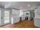 Modern kitchen with stainless appliances, white cabinets, and wood floors at 5254 Greenpoint Dr, Stone Mountain, GA 30088