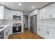 Bright kitchen featuring stainless steel appliances, white cabinetry, and modern lighting at 5254 Greenpoint Dr, Stone Mountain, GA 30088