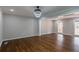 Bright living room with hardwood floors, white trim, and modern light fixture at 5254 Greenpoint Dr, Stone Mountain, GA 30088