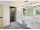 Bright bathroom featuring a large vanity, a walk-in shower, and patterned floors at 6025 Golf View Xing, Locust Grove, GA 30248