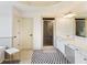 Spacious bathroom with a large vanity, tub, walk-in shower and patterned floors at 6025 Golf View Xing, Locust Grove, GA 30248