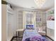 Bedroom featuring an organized closet, single bed, and decorative chandelier at 6025 Golf View Xing, Locust Grove, GA 30248