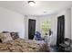 Cozy bedroom with comfortable bed, a window with natural light, and a modern gaming setup at 6025 Golf View Xing, Locust Grove, GA 30248