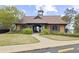 Exterior of the clubhouse with covered porch and well-maintained lawn at 6025 Golf View Xing, Locust Grove, GA 30248