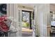 Bright foyer showcasing an open door with sidelights, elegant molding, and a glimpse of the lush front yard at 6025 Golf View Xing, Locust Grove, GA 30248