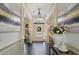 Inviting foyer featuring marble artwork and luxury chandeliers, leading to a paneled front door at 6025 Golf View Xing, Locust Grove, GA 30248