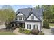 Attractive two-story home with a covered porch, detailed landscaping, and a winding walkway leading to the entrance at 6025 Golf View Xing, Locust Grove, GA 30248
