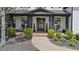 Charming front porch with decorative columns, seasonal wreaths, and manicured shrubbery, inviting you to come inside at 6025 Golf View Xing, Locust Grove, GA 30248