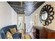 Elegant hallway featuring a decorative ceiling, wood accents, and comfortable blue seating at 6025 Golf View Xing, Locust Grove, GA 30248