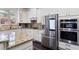 Modern kitchen featuring white cabinets, granite countertops, and stainless steel smart appliances at 6025 Golf View Xing, Locust Grove, GA 30248