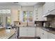 Bright kitchen with granite countertops, white cabinets, and modern stainless steel appliances at 6025 Golf View Xing, Locust Grove, GA 30248