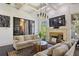 Bright living room with a coffered ceiling, stone fireplace, and large windows showcasing the exterior at 6025 Golf View Xing, Locust Grove, GA 30248