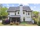 Back of house featuring a screened porch, deck area and a grassy yard ideal for entertaining or relaxing at 6025 Golf View Xing, Locust Grove, GA 30248