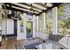 Relaxing screened porch with brick floor, comfortable seating and views of the serene backyard at 6025 Golf View Xing, Locust Grove, GA 30248