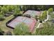 Aerial view of community tennis courts with green and red playing surfaces at 6025 Golf View Xing, Locust Grove, GA 30248