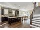Modern kitchen with an island and barstool seating next to an open-concept dining and living room space at 1329 Booth Ave, Atlanta, GA 30318