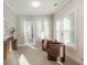 Bright living room with large window, two armchairs, and a doorway to the bathroom at 1329 Booth Ave, Atlanta, GA 30318