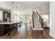 Open concept living space featuring a modern kitchen with a large island, hardwood floors, and a staircase at 1329 Booth Ave, Atlanta, GA 30318