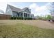 Large backyard showcasing green grass, mature trees, and a wooden fence at 1344 Chipmunk Forest Chase, Powder Springs, GA 30127