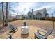 Fire pit area surrounded by Adirondack chairs in a spacious backyard at 1344 Chipmunk Forest Chase, Powder Springs, GA 30127