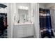 Bathroom with white vanity and shower with decorative curtain at 1344 Chipmunk Forest Chase, Powder Springs, GA 30127