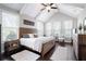 Vaulted bedroom with a rustic wooden bed frame, hardwood floors, and plenty of windows at 1344 Chipmunk Forest Chase, Powder Springs, GA 30127
