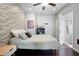 Bedroom with exposed brick wall, hardwood floors, and natural light at 1344 Chipmunk Forest Chase, Powder Springs, GA 30127