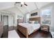 Vaulted bedroom with a rustic wooden bed frame, hardwood floors, and plenty of windows at 1344 Chipmunk Forest Chase, Powder Springs, GA 30127