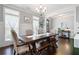 Charming dining room with hardwood floors, modern decor, and abundant natural light at 1344 Chipmunk Forest Chase, Powder Springs, GA 30127