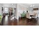 Open-concept dining room flows to a living area, featuring hardwood floors and stylish decor at 1344 Chipmunk Forest Chase, Powder Springs, GA 30127