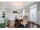 Elegant dining room features wainscoting, hardwood floors, and a stylish chandelier at 1344 Chipmunk Forest Chase, Powder Springs, GA 30127