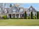 Charming two-story home features a welcoming front porch and beautifully landscaped front yard at 1344 Chipmunk Forest Chase, Powder Springs, GA 30127