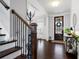 Inviting foyer showcases gleaming hardwood floors and staircase with iron spindles at 1344 Chipmunk Forest Chase, Powder Springs, GA 30127