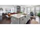 Open-concept kitchen with island, stainless steel appliances, and views of the dining and living areas at 1344 Chipmunk Forest Chase, Powder Springs, GA 30127