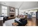 Open-concept living room with a brick fireplace, kitchen, and hardwood floors at 1344 Chipmunk Forest Chase, Powder Springs, GA 30127