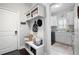 Mudroom featuring built-in storage, bench with hooks, and a doorway to the laundry room at 1344 Chipmunk Forest Chase, Powder Springs, GA 30127