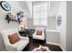 A cozy sitting room with natural light, hardwood floors, and comfortable chairs at 1344 Chipmunk Forest Chase, Powder Springs, GA 30127