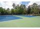 Community tennis courts featuring well-maintained blue and green surfaces at 1344 Chipmunk Forest Chase, Powder Springs, GA 30127