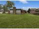 Large backyard with a stone fireplace and a well-maintained lawn at 1899 Stratford Arms Dr, Morrow, GA 30260