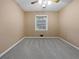 Neutral bedroom featuring neutral carpeting and a window overlooking the yard at 1899 Stratford Arms Dr, Morrow, GA 30260