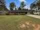 Charming brick ranch home with a large front yard and mature trees at 1899 Stratford Arms Dr, Morrow, GA 30260
