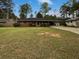 Charming brick ranch home with a large front yard and mature trees at 1899 Stratford Arms Dr, Morrow, GA 30260