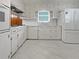 Bright kitchen with white cabinets, modern appliances, and tile flooring at 1899 Stratford Arms Dr, Morrow, GA 30260