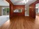 The vintage kitchen features wood paneling, white countertops, and a view to the fenced back yard at 1899 Stratford Arms Dr, Morrow, GA 30260